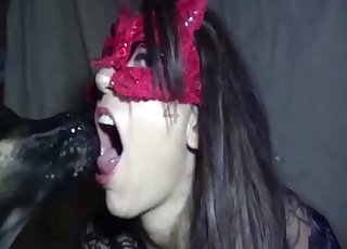 Masked brunette is sucking a big boner
